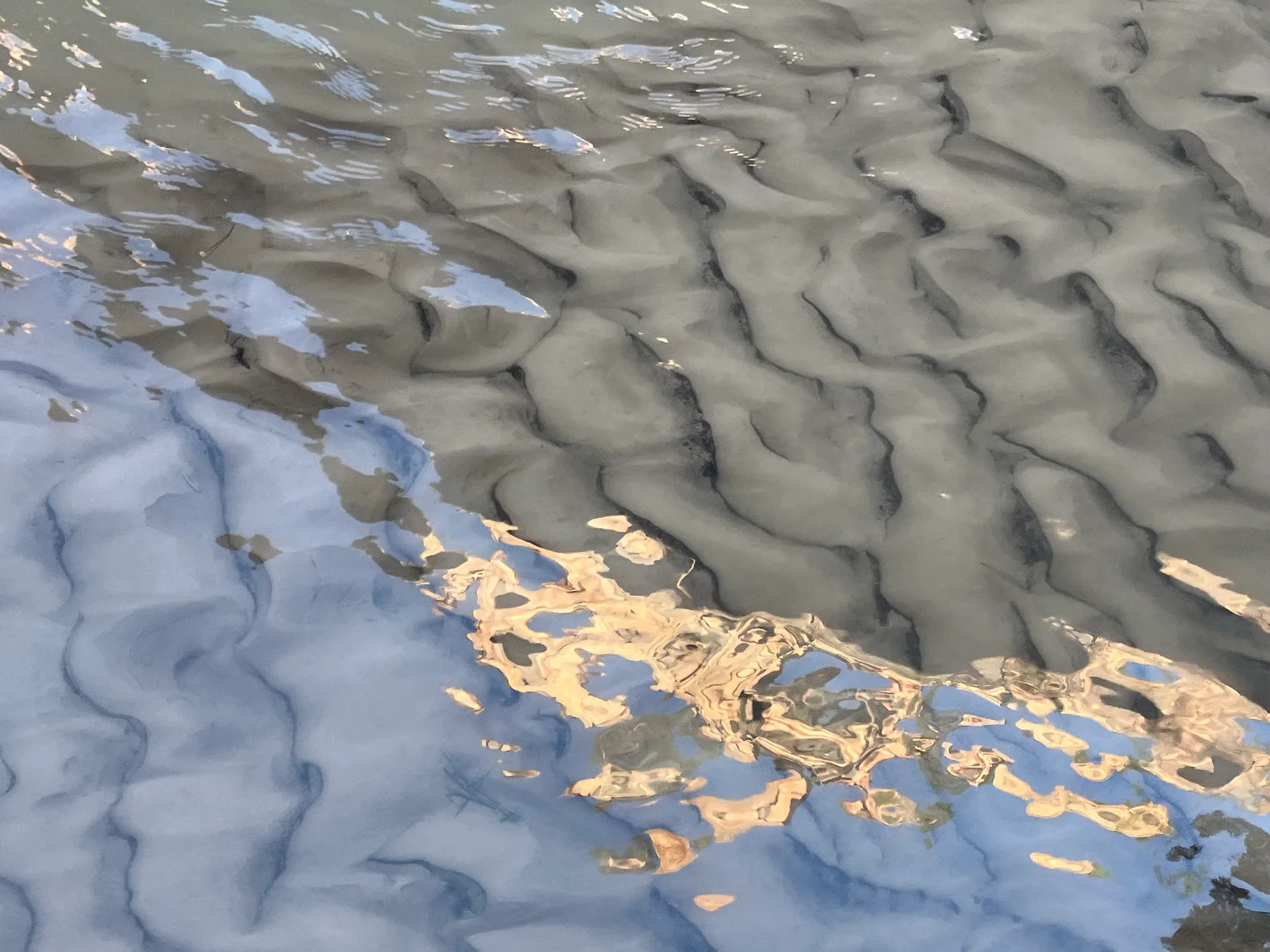 Water surface reflection — architectural abstraction for the Interlaken practice (between the lakes).